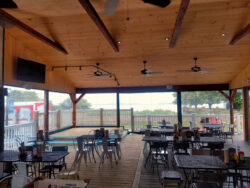 The bead board ceiling and decorative collar ties are simple but effective details to give this space some character. The stage in the rear corner is perfect for live music events.